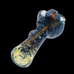 Glass pipe with blue and yellow swirls, isolated on a black background.