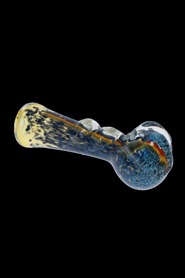 Blue and yellow glass pipe isolated on a black background.