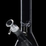 Clear glass bong with ice catcher and flared base, isolated on black.