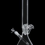 Clear glass bong with ice catcher, isolated on black.