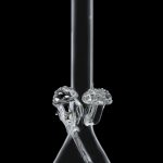 Clear glass bong with mushroom-shaped percolators, isolated on a black background.