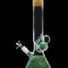 Green glass bong with intricate leaf patterns and a spherical accent, isolated on a black background.