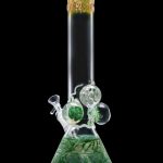 Green glass water pipe (bong) with intricate swirling designs and bubbling percolators.