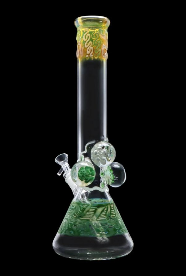 Green glass water pipe (bong) with intricate swirling designs and bubbling percolators.
