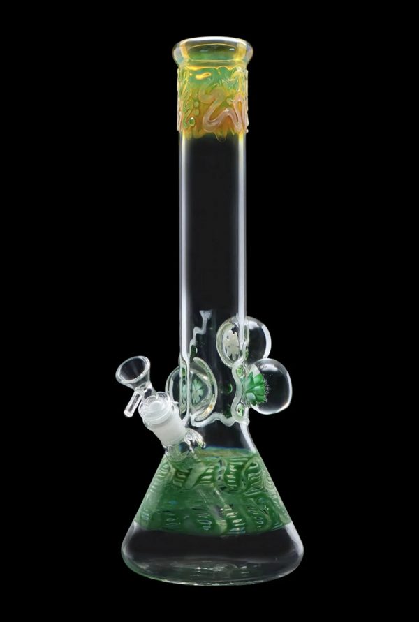 Green glass bong with intricate swirling patterns and bubble percolator, isolated on black.