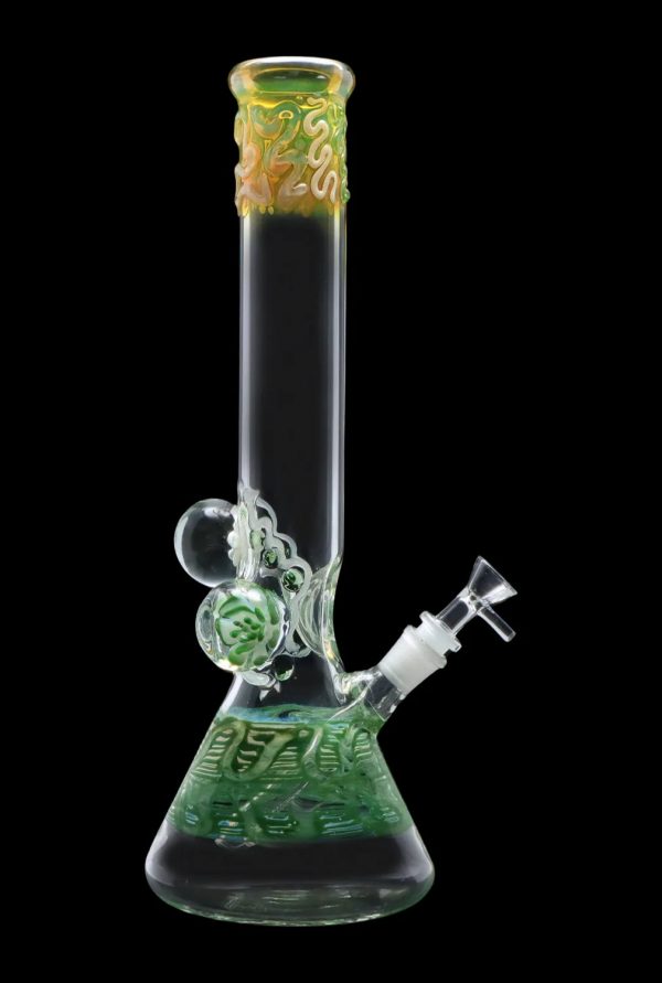 Green glass water pipe (bong) with intricate sculpted details.