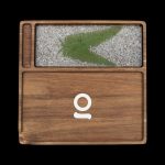 Wooden cannabis storage box with a plant-fiber display section and a white omega symbol on the front.