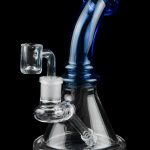 Blue and clear glass dab rig with a quartz banger, isolated on black.