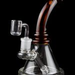 A clear glass rig with a colored mouthpiece and a quartz banger, isolated on a black background.