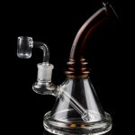 Clear glass dab rig with a quartz banger, isolated on a black background.