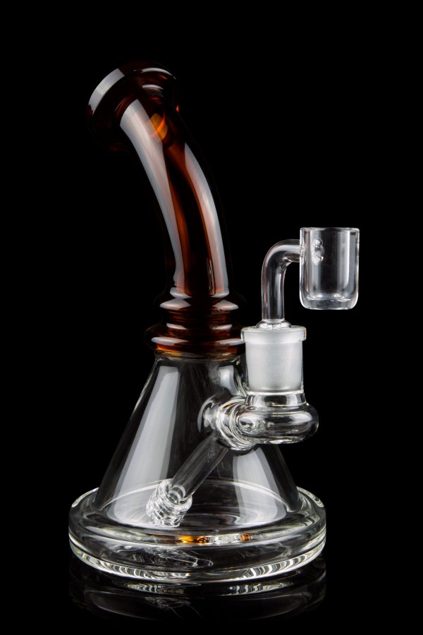 A glass bong with a flared base and amber-colored neck, featuring a quartz banger.