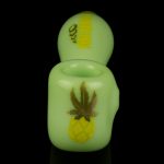 Glowing green cannabis oil vape pen with pineapple and leaf design.