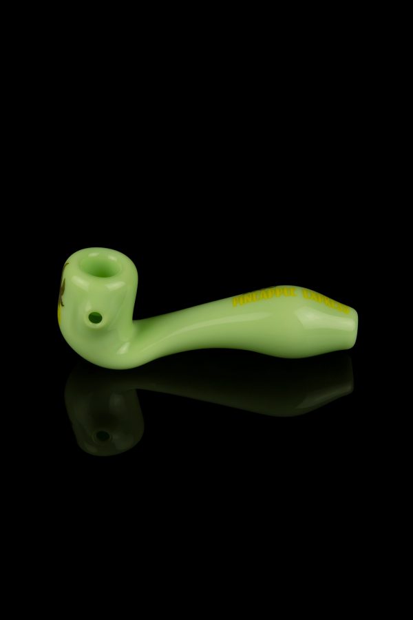 Green glass pipe with a glossy finish, displayed on a reflective black surface.