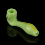 Lime green glass pipe with embossed text, reflecting on a black surface.