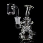 Clear glass dab rig with intricate design and quartz banger.