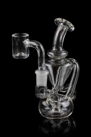 Clear glass dab rig with intricate percolators, isolated on a black background.