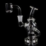 Clear glass dab rig with a quartz banger, isolated on a black background.