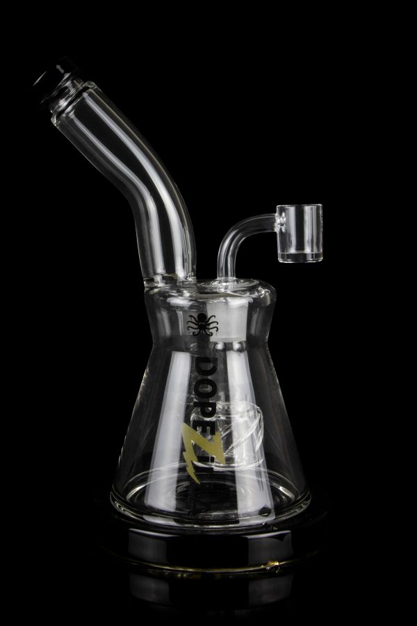 Glass water pipe (bong) with intricate design and clear glass, isolated on a black background.