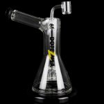 Clear glass oil rig with a dab nail and intricate internal diffusion, reflecting on a black surface.