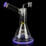 A clear glass water pipe (rig) with purple accents and a quartz nail, isolated on a black background.