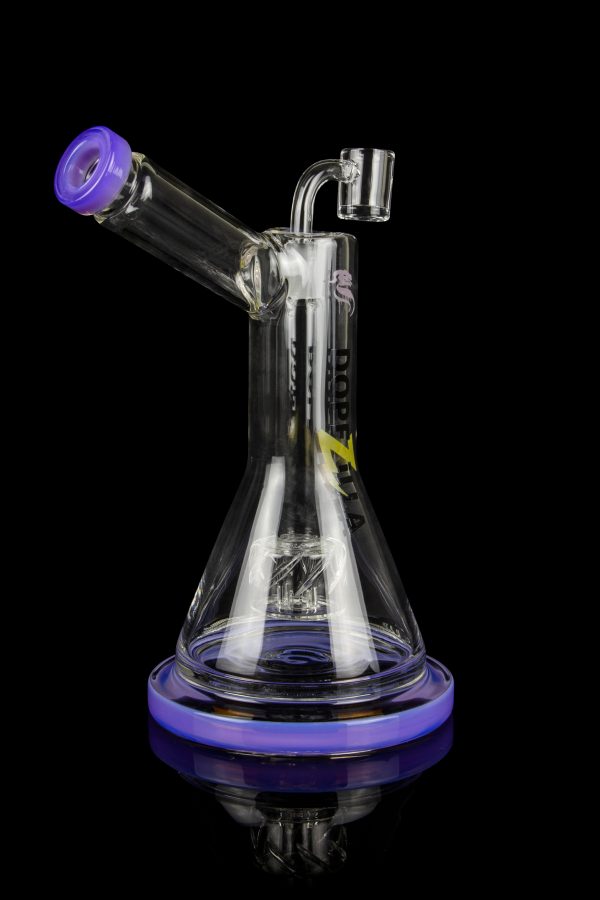 Clear glass water pipe (bong) with purple accents and intricate percolator filtration system, isolated on a black background.