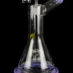 Purple and clear glass dab rig with intricate internal diffusion and a quartz banger.