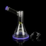 Glass water pipe (bong) with purple accents and accompanying glass bongs attachments on a black background.