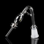 Clear glass oil rig attachment with a rounded reservoir and angled mouthpiece, reflecting on a black surface."