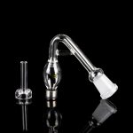 Clear glass bubbler and oil rig attachment on a reflective black surface.