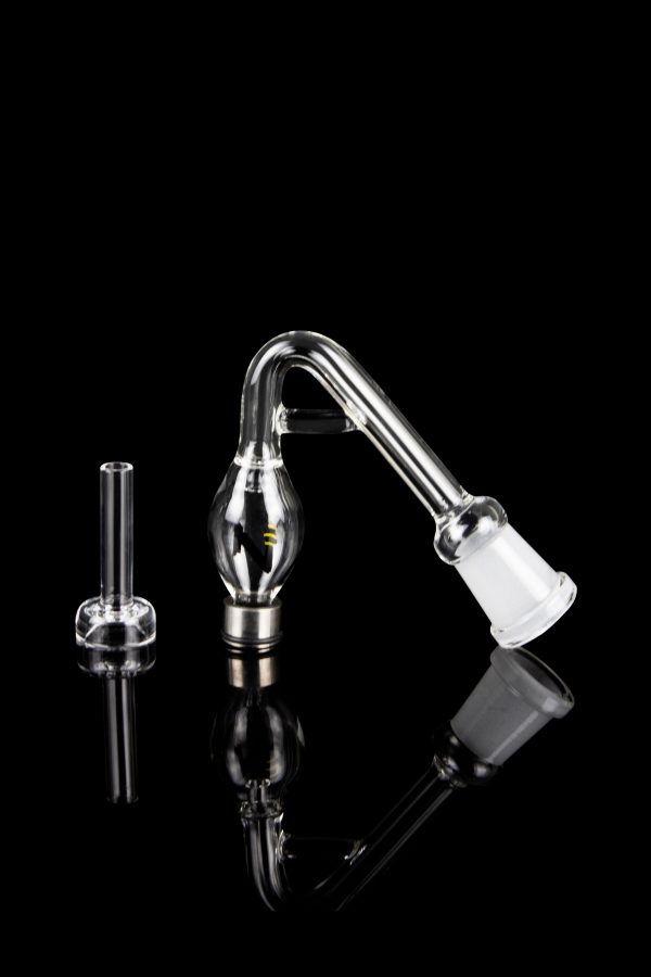 Clear glass bubbler and oil rig attachment on a reflective black surface.