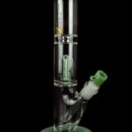 Green glass water pipe (bong) with intricate perc filtration system.