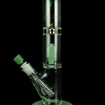 Green glass bong with percolator, isolated on black.