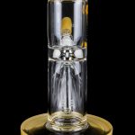 Clear glass water pipe (rig) with a golden base and mouthpiece cap, studio shot on a black background.