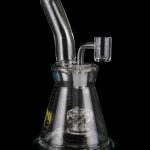 Clear glass dab rig with intricate percolator and quartz banger, isolated on a black background.
