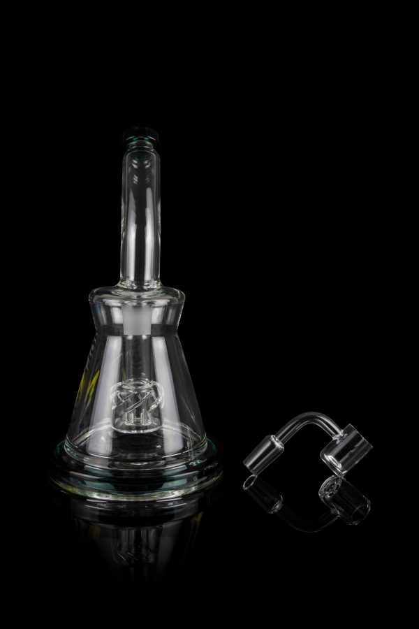 Clear glass rig with intricate percolator and accompanying quartz banger, isolated on a black background.