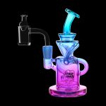 Neon pink and blue glass rig with a quartz dab nail, branded “Stash Shack.”