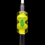 A glass oil rig with a green liquid inside, branded with “Freak Street” in green and black.