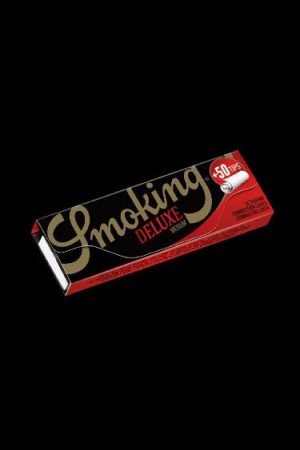 Red pack of Smoking Deluxe rolling papers and tips against a black background.