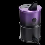 Purple cannabis vaporizer with a power button and attached mouthpiece, isolated on a black background.