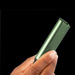 A hand holding a sleek, metallic green cannabis vaporizer pen against a black background.