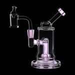 Pink glass dab rig with a quartz banger and accessories, isolated on a black background.