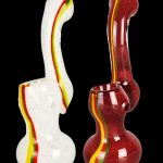 Two glass bubblers with red, yellow, and green stripes against a black background.