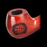 Red glass pipe with a decorative etching resembling The Shire from *Lord of the Rings*.