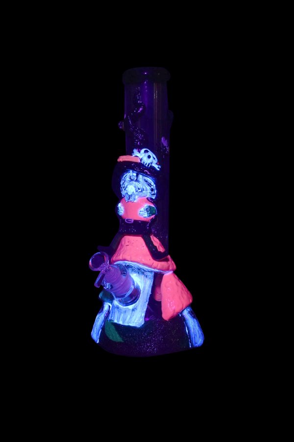 Glowing glass water pipe with a detailed, colorful sculptural design, illuminated against a black background.