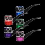 Assortment of colorful, glitter-filled glass bubblers against a black background.