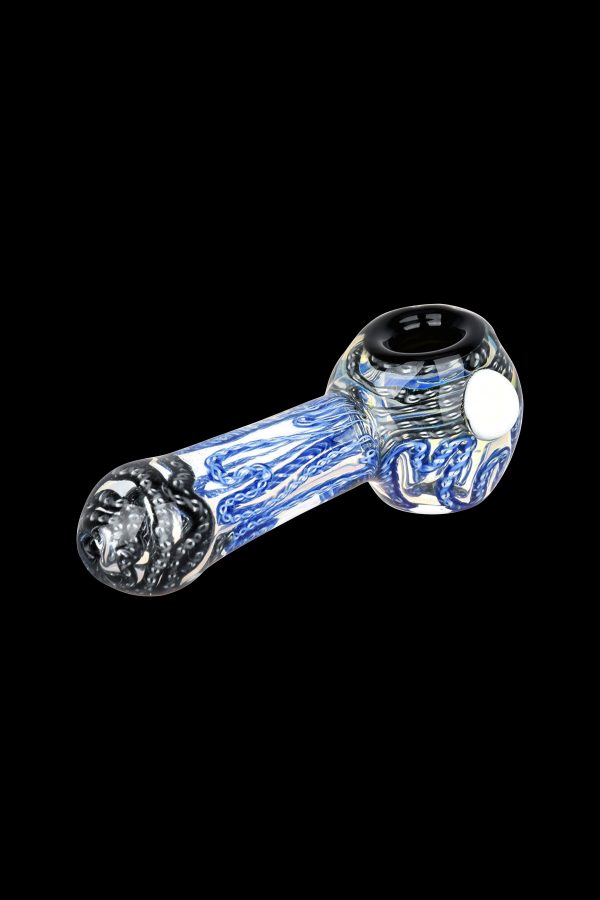 Blue and white glass smoking pipe on a black background.