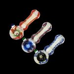 Colorful glass pipes for smoking cannabis displayed against a black background.