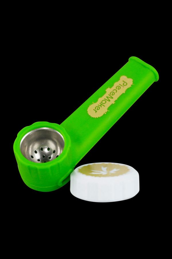 A side view of the PieceMaker "Karma" Silicone Pipe, showcasing its curved design and green hue against a dark backdrop.