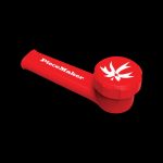 Close-up of the PieceMaker "Karma" Silicone Pipe, showcasing its rounded, red design against a stark black background.