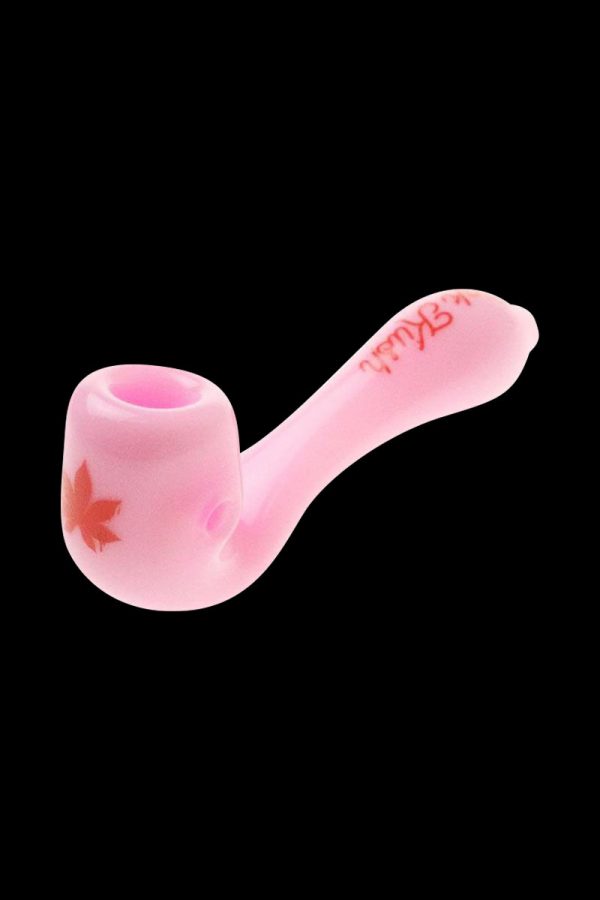 A close-up of the “Puff Puff Pass “Pink Kush” Strain Pipe, showing a curved, pink glass pipe against a plain black background.